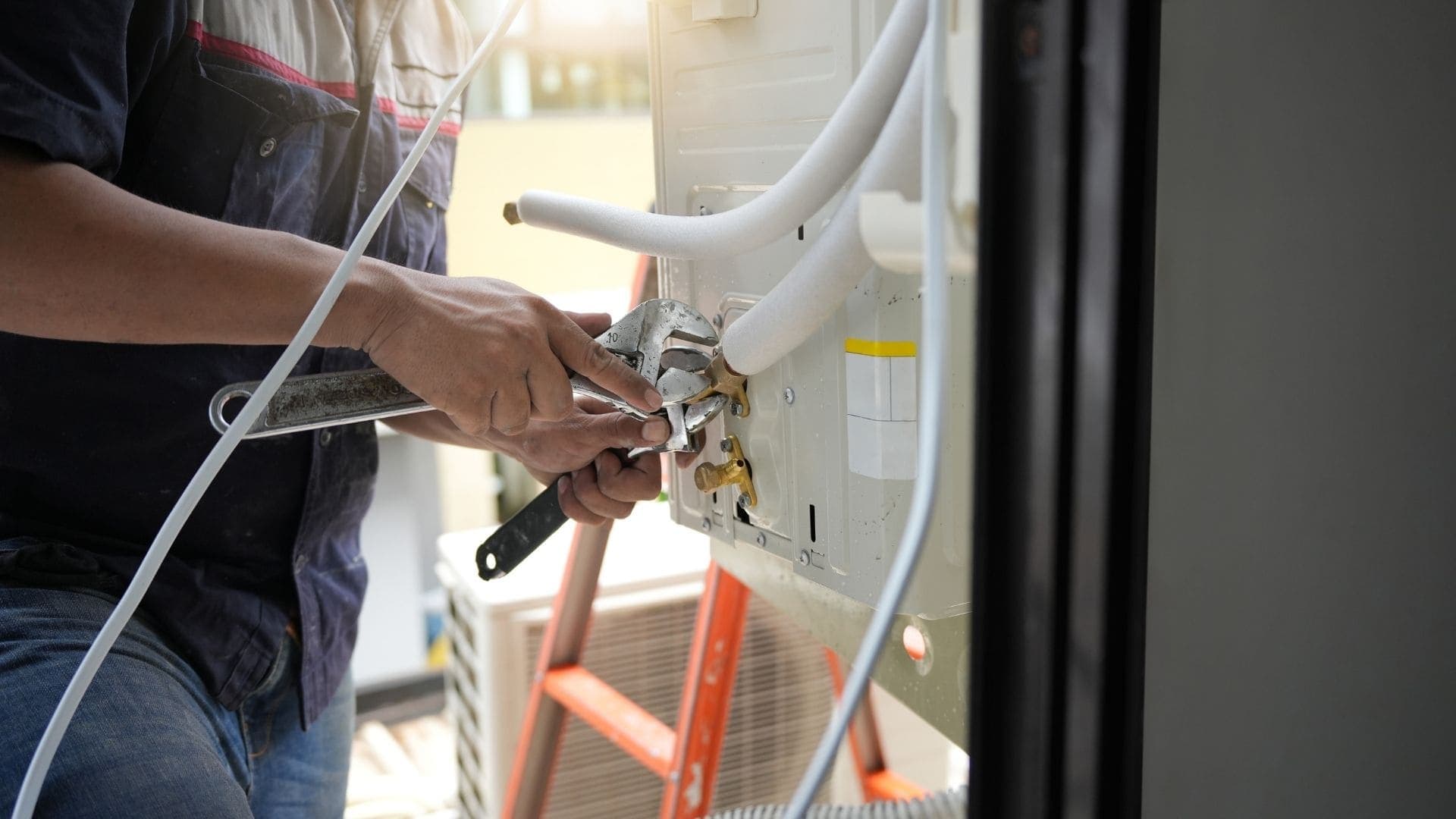 Wheelhouse technician connecting refrigerant lines on a mini-split unit
