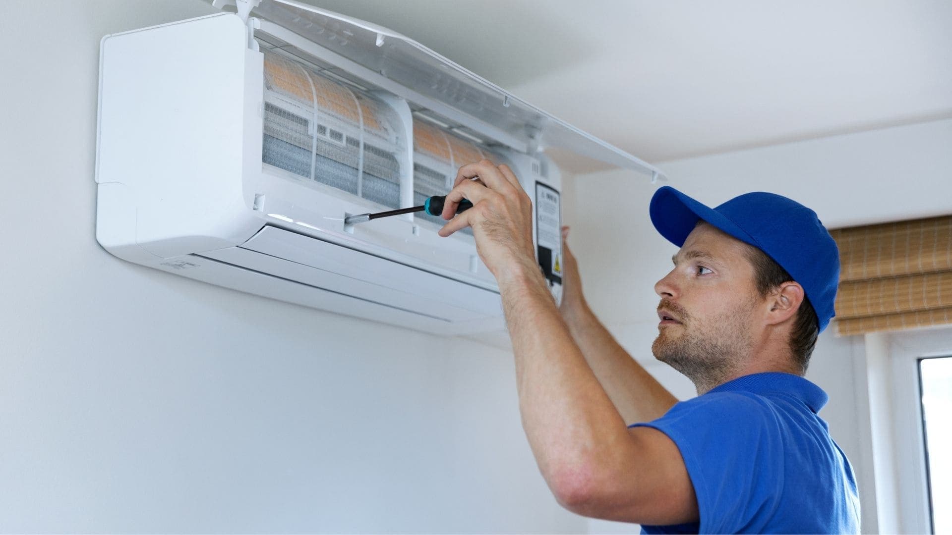 Technician installing a new wall-mounted HVAC unit